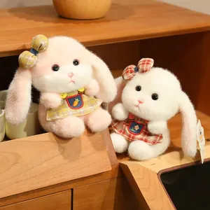 Cute long-eared plush rabbit dolls in pink and white dresses with plaid patterns