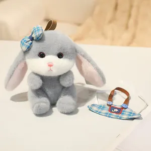 Detail of grey plush rabbit toy with blue checkered bow and flower embroidery charm