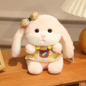 Detailed plush pink bunny with yellow plaid dress and carrot embroidery on a wooden table