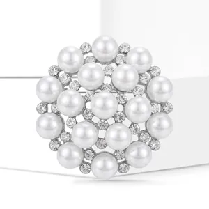 Detailed macro view of an elegant round pearl brooch with sparkling rhinestone accents