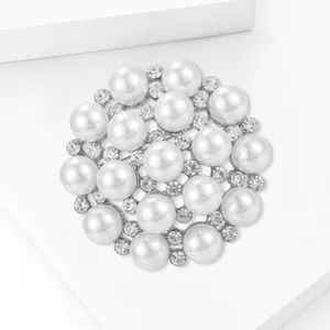 Macro view of snowflake pearl brooch with white pearls and sparkling rhinestones