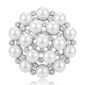 Elegant silver-tone snowflake brooch featuring white pearls and shimmering rhinestones