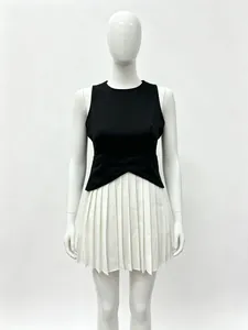 Detail of cross-over pleated waist design on a black and white sleeveless dress