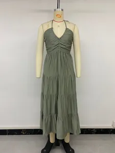 Detail of sage green halter neck tiered maxi dress with smocked bodice texture