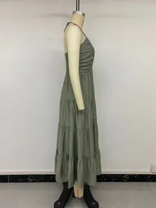 Detailed side view of sage green halter tiered dress with smocked chest texture