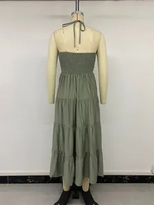 Detail view of the smocked back and tiered skirt on this halter neck summer dress