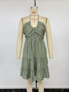 Detail of sage green halter tiered mini dress with pleated chest and smocked bodice