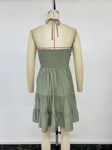 Detail of the smocked back design and halter neck ties on this green summer dress