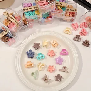 Mini macaron hair clips set with matte flower and star shapes in a transparent gift box