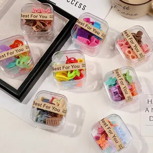 Detail of colorful mini hair claw clips in gift boxes with handmade sealing stickers
