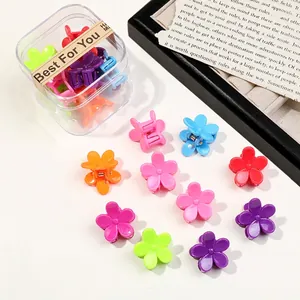 Macro shot of colorful flower hair claw clips in a transparent plastic gift box set