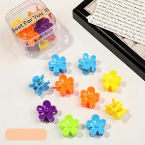 Macro shot of colorful mini flower hair clips in a transparent storage box