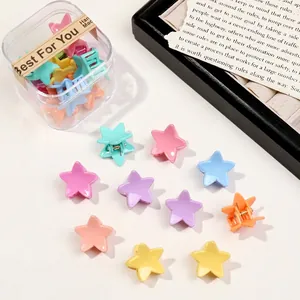 Macro view of colorful star-shaped hair clips in macaron colors and clear packaging box