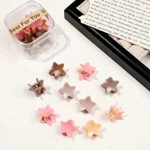 Detail of star-shaped hair claw clips in matte Morandi colors with a transparent gift box