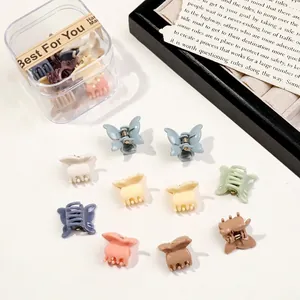 Close-up of butterfly hair clips in macaron colors with a clear storage box