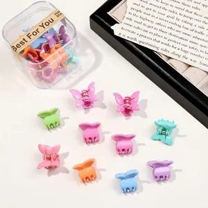 Macro view of colorful butterfly mini hair claws in a clear plastic box