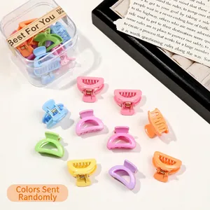 Close-up of assorted candy-colored mini hair claws in a transparent storage box