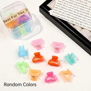 Close-up of colorful mini hair claws in a transparent storage box with random colors
