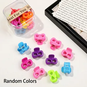 Detail of colorful mini bow hair clips in a gift box with a kraft paper decorative band