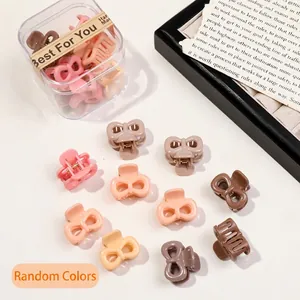 Detailed view of mini butterfly hair claws in Morandi colors with a clear storage box