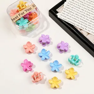 Mini macaron flower hair claws in a clear storage box with random mixed colors
