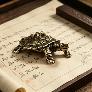 Close-up of handmade brass tortoise figurine with vintage texture on a scroll
