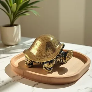 Macro detail of a vintage brass turtle figurine on a wooden tray with warm lighting