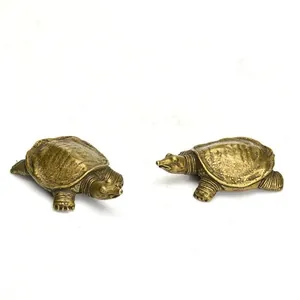 Macro detail of solid brass turtle figurines showing realistic head and shell textures