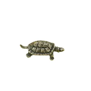 Handcrafted vintage brass turtle figurine with detailed shell texture on white background