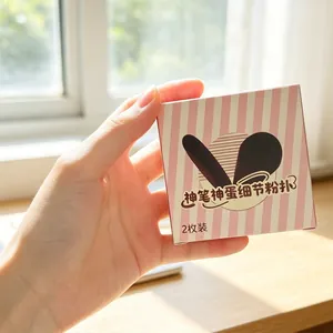 Macro shot of two precision makeup sponges in pink striped packaging box