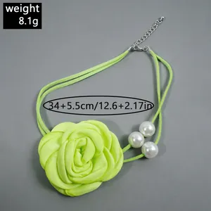 Detail view of neon green fabric rose choker necklace with white pearls and size info
