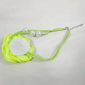 Detail view of the green fabric flower backing and adjustable lobster clasp chain