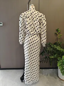 Detail showing back view of vintage polka dot dress with delicate white lace trim edges