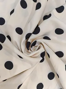 Close-up of lightweight polka dot chiffon fabric with elegant drape and soft texture