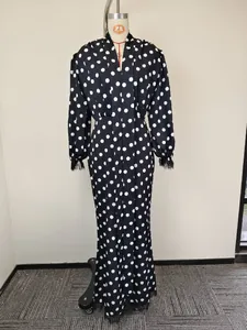 Detail of elegant V-neck polka dot dress with eyelash lace trim on the sleeve cuffs