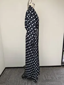 Detail view of vintage polka dot dress with V-neckline and puffed sleeves on a model