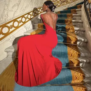 Close-up of red satin backless evening gown with luxury gold chain detail on the back