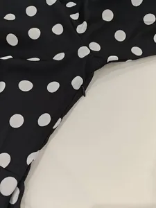 Detail of invisible zipper closure on retro black and white polka dot V-neck dress