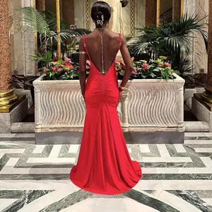 Macro view of the backless red satin evening dress with chain and ruched details