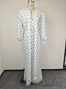 Detail of V-neck long dress featuring sky blue polka dots and white lace cuffs