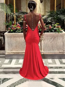 Elegant red backless long evening dress with deep V-cut and decorative back chains
