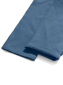 Close-up detail of blue cotton linen pants hem showing breathable fabric texture