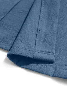 Detailed macro view of the grey cotton blend fabric texture and stitching on the hem