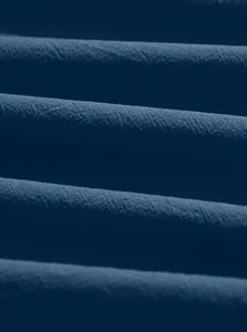Close-up of deep navy blue pure cotton fabric texture and fine plain weave detail