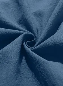 Detailed close-up of dark blue cotton linen fabric texture with natural woven fibers
