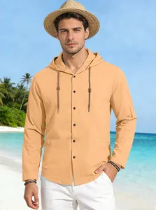 Men's hooded cotton shirt detail showing apricot fabric texture and button design on beach
