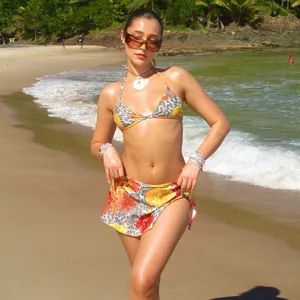 Detail of leopard print and floral bikini with matching mini skirt on sunny beach