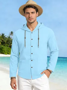 Close-up of light blue hooded cotton shirt texture with brown buttons on tropical beach