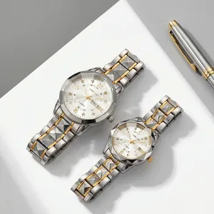 Close-up of luxury gold-tone stainless steel couple watches with diamond indices and date display