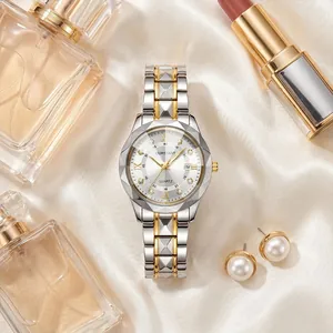 Close-up of luxury women's watch with gold and silver steel band on silk background